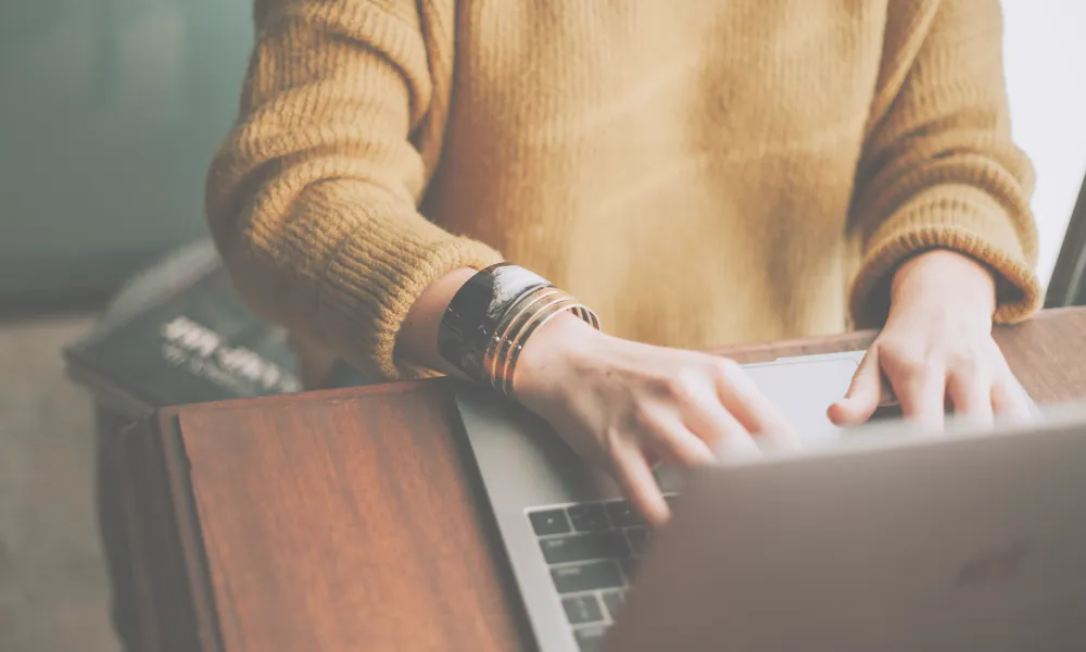 Woman typing a promotion request letter.
